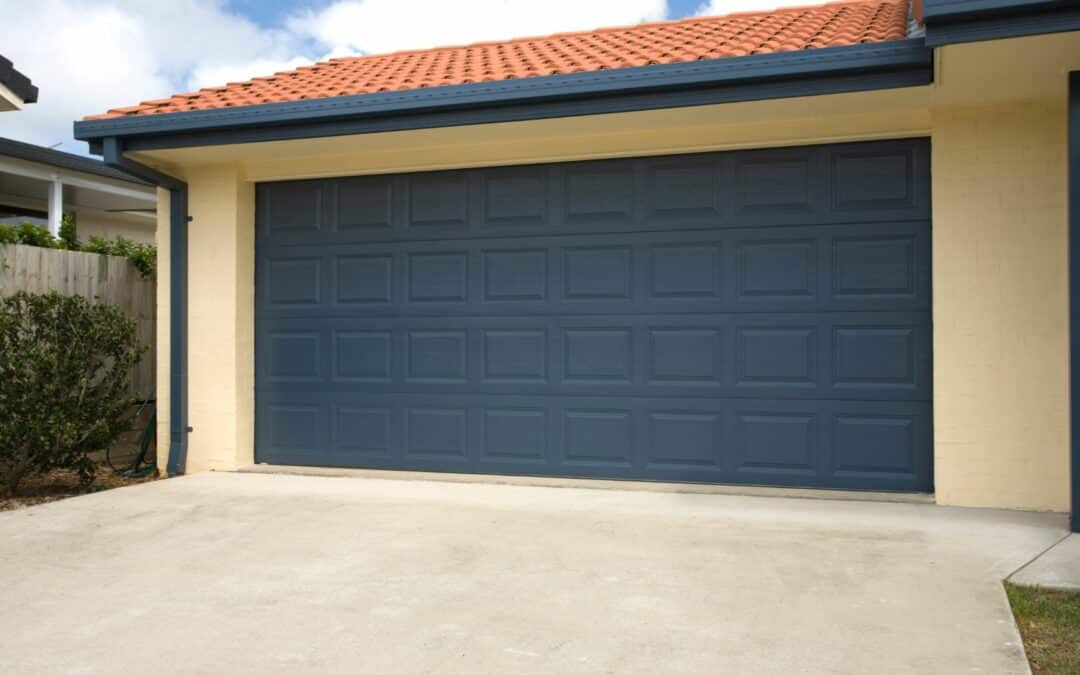 A blue garage door made of steel, one of the best garage door materials