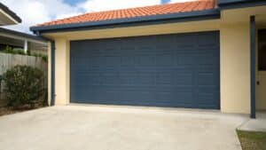 A blue garage door made of steel, one of the best garage door materials