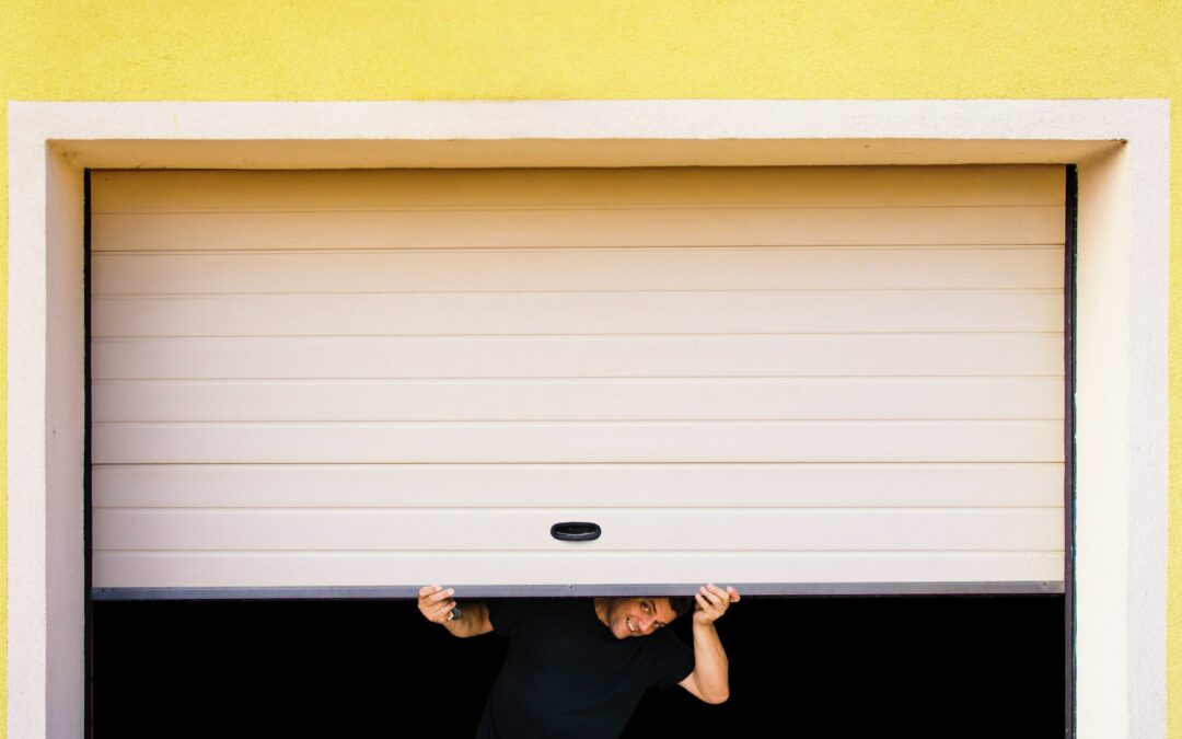 A homeowner lifts up his garage door as he prepared to implement garage door ideas to enhance curb appeal.