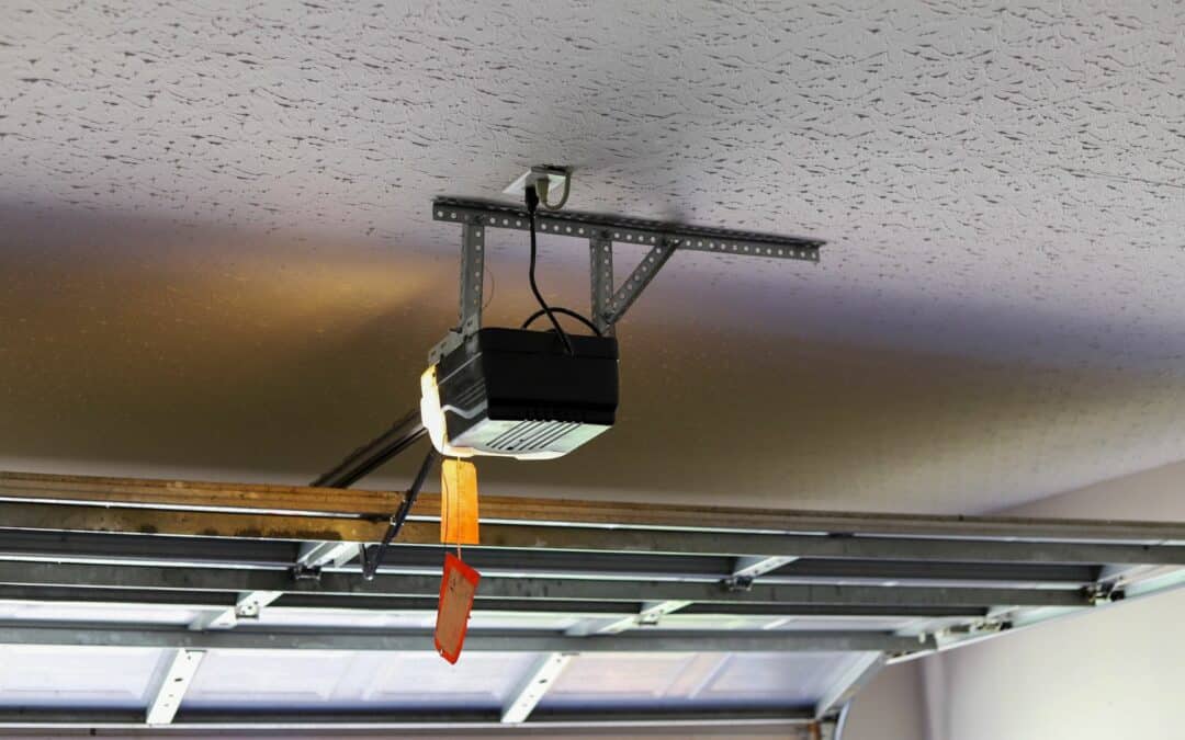 A garage door opener that is mounted on the ceiling, one of many types of garage door motors