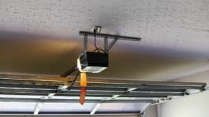 A garage door opener that is mounted on the ceiling, one of many types of garage door motors